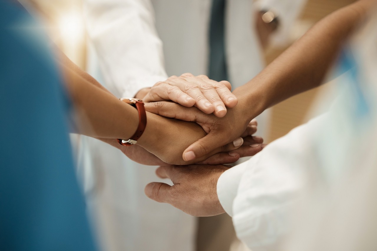Hands, collaboration and healthcare with a medicine team in a huddle or circle in the hospital for insurance or medical. Teamwork, motivation and innovation with a doctor and nurse group in a clinic
