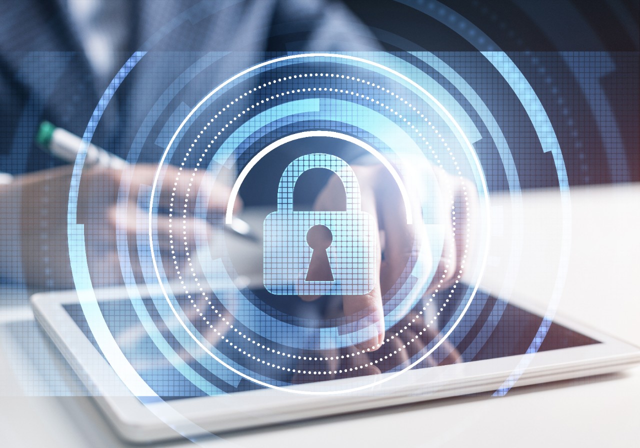 Cyber security and data privacy protection. Virtual locking padlock element. Double exposure concept with businessman working at tablet. Protect personal data and privacy from cyberattack and hacker